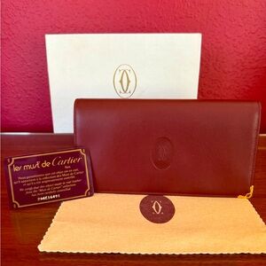 CARTIER BORDEAUX DOUBLE FLAP WALLET from the MUST DE CARTIER COLLECTION.
